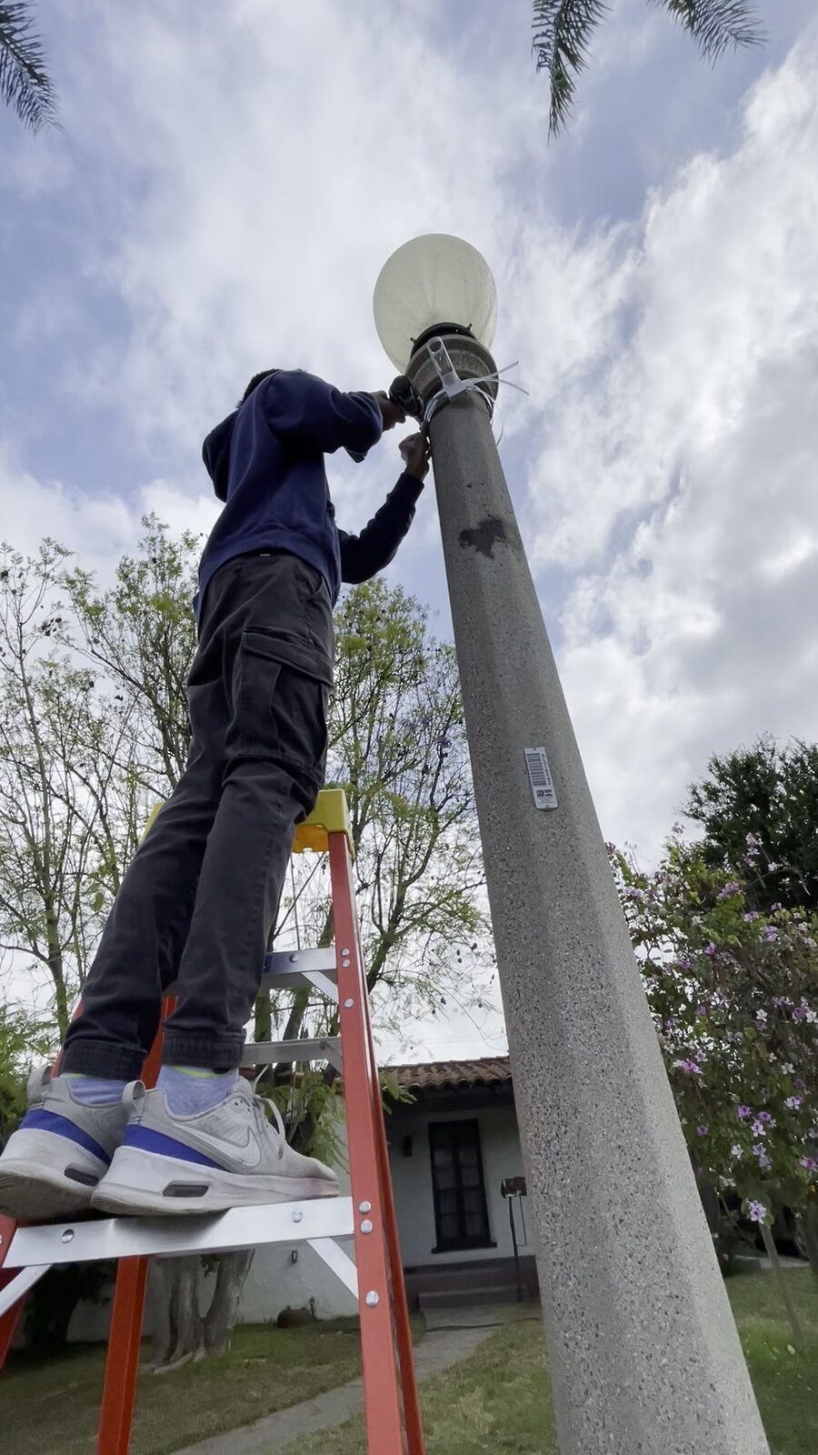 Volunteers installing a flag on a streetlight